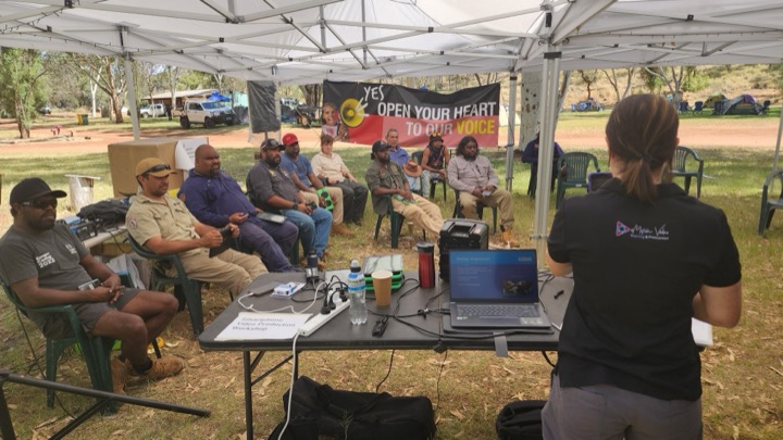 Suzie presenting a video training session to a community group on Country