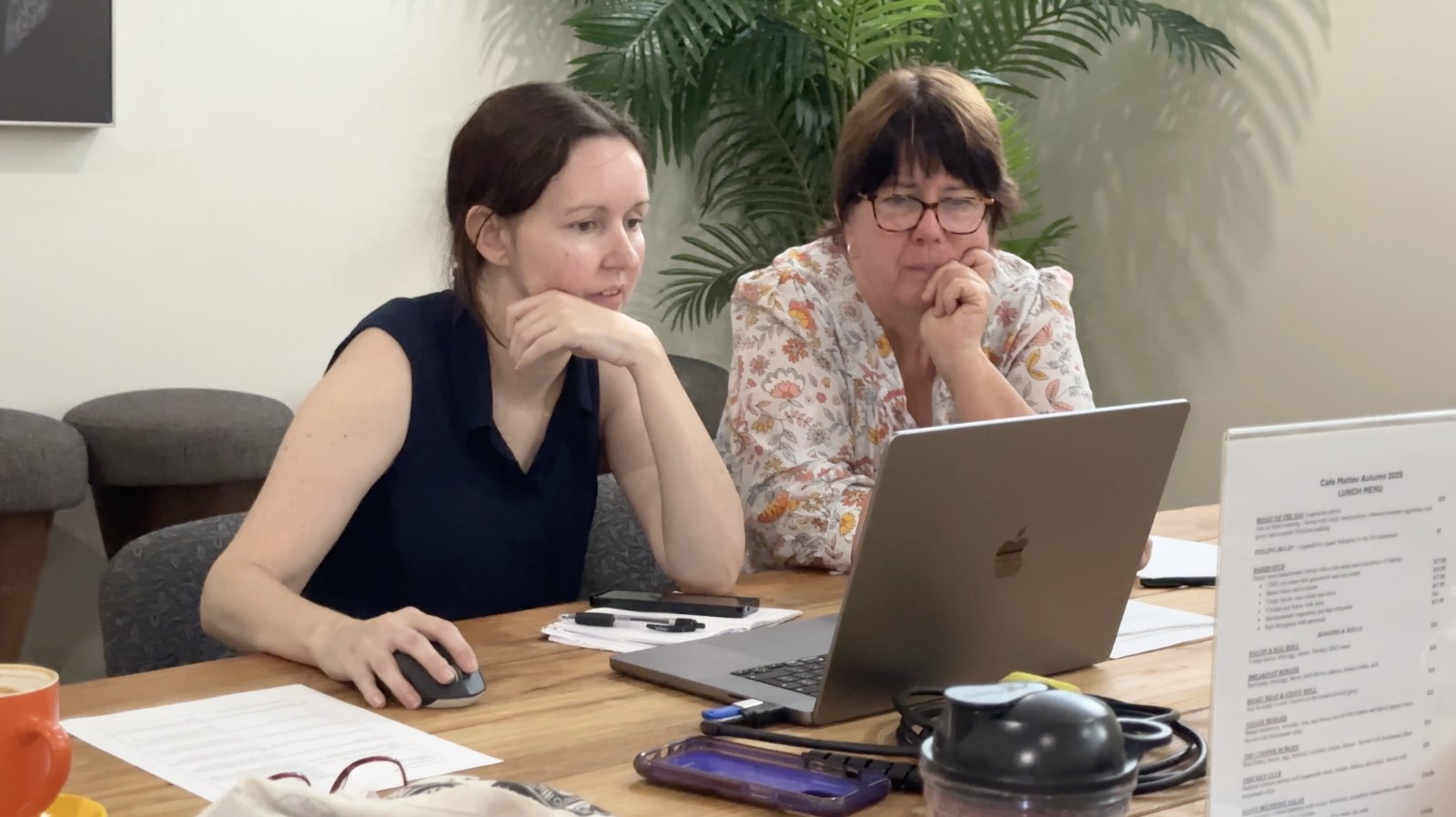 Two NQAR volunteers editing their video together on a laptop
