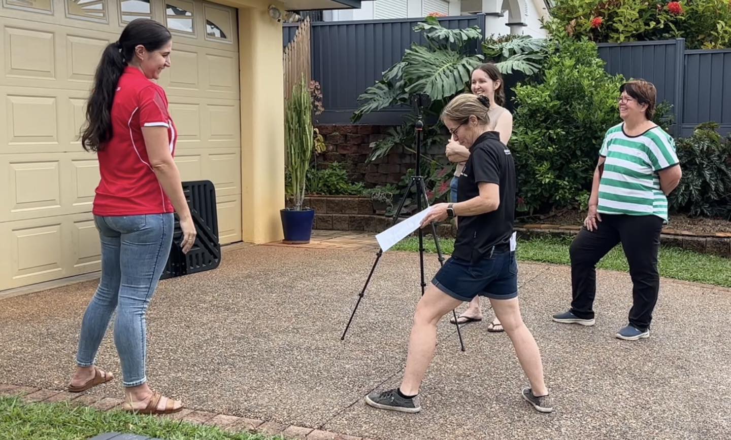 North Queensland Animal Rescue volunteers filming in a front yard