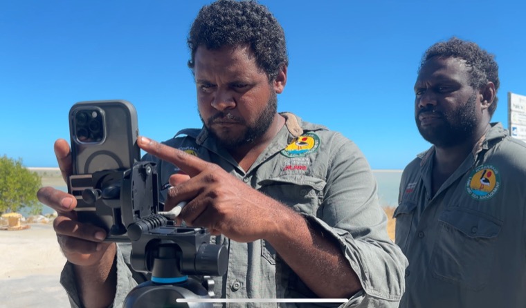 Pormpuraaw Land and Sea Rangers filming on Country with a phone