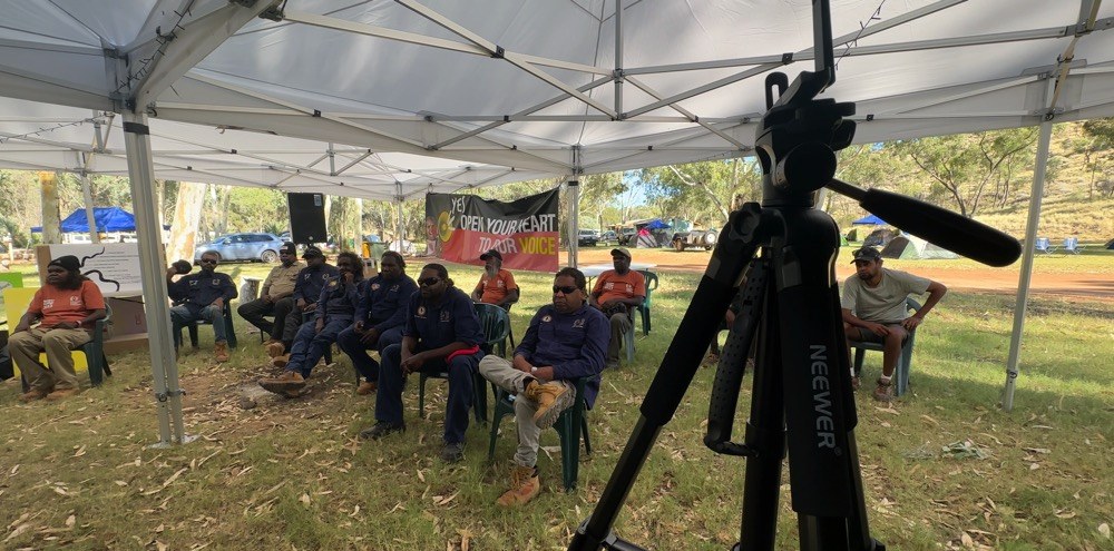 A team learning video together at an on-country training session