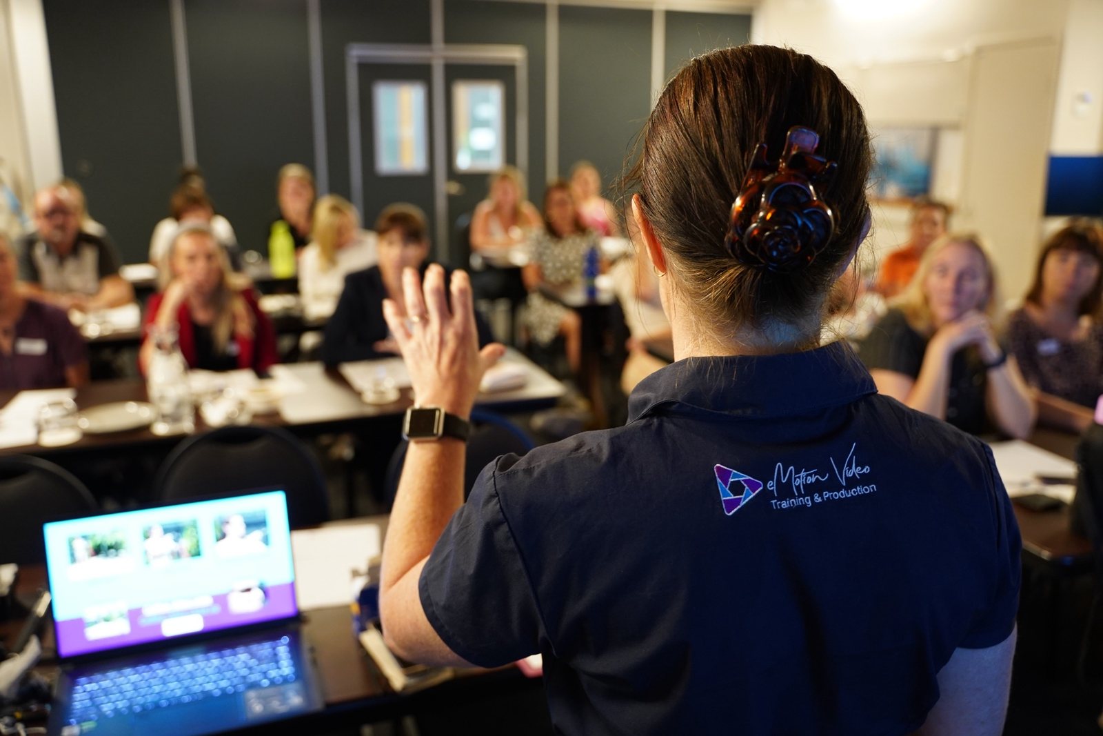 Suzie training a room of professionals in AI and video